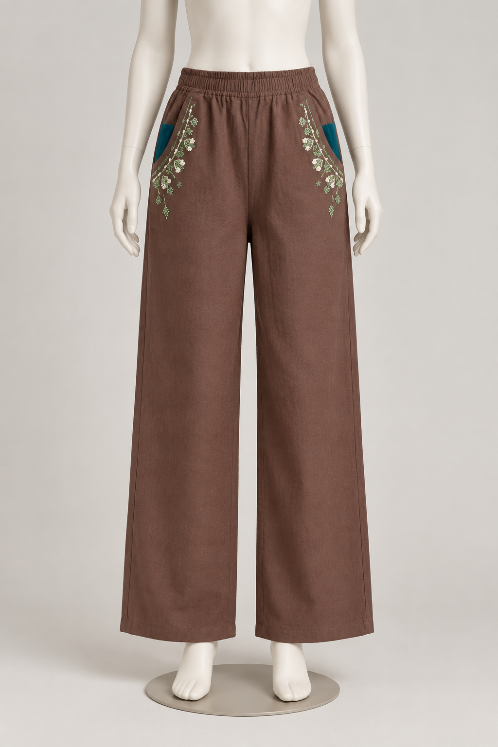 Full-length front view of brown wide-leg cotton pants with green floral embroidery